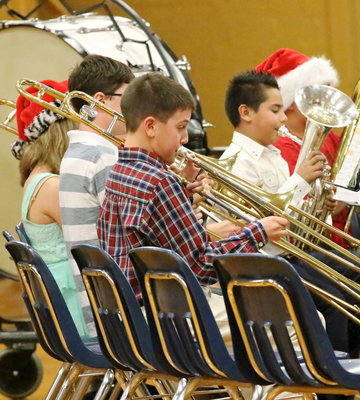 Image: Colby Hampton and the the 6th Grade Band trombone section give it their all.