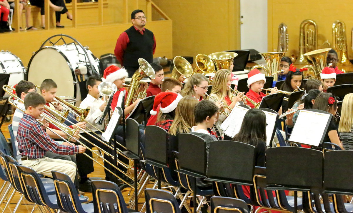 Image: Band director Jesus Perez watches over his 6th grade band kids with an obvious pride.