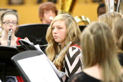 Image: Brycelyn Richards rests her flute on her shoulder while awaiting her next notes to play.
