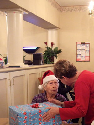 Image: Ann Rayner handing out presents to the residents.
