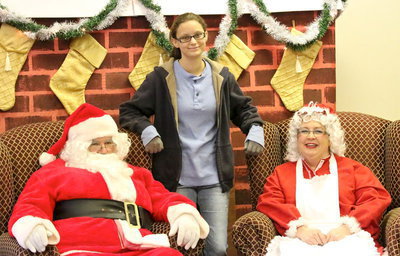 Image: McKenzie Goodwin tells Santa and Mrs. Claus what she truly wants for Christmas.