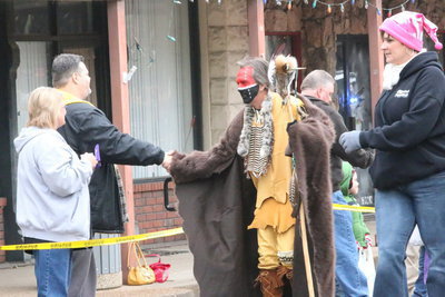 Image: Ray Don Mitchell of The Uptown Cafe greets an Indian on the parade trail.