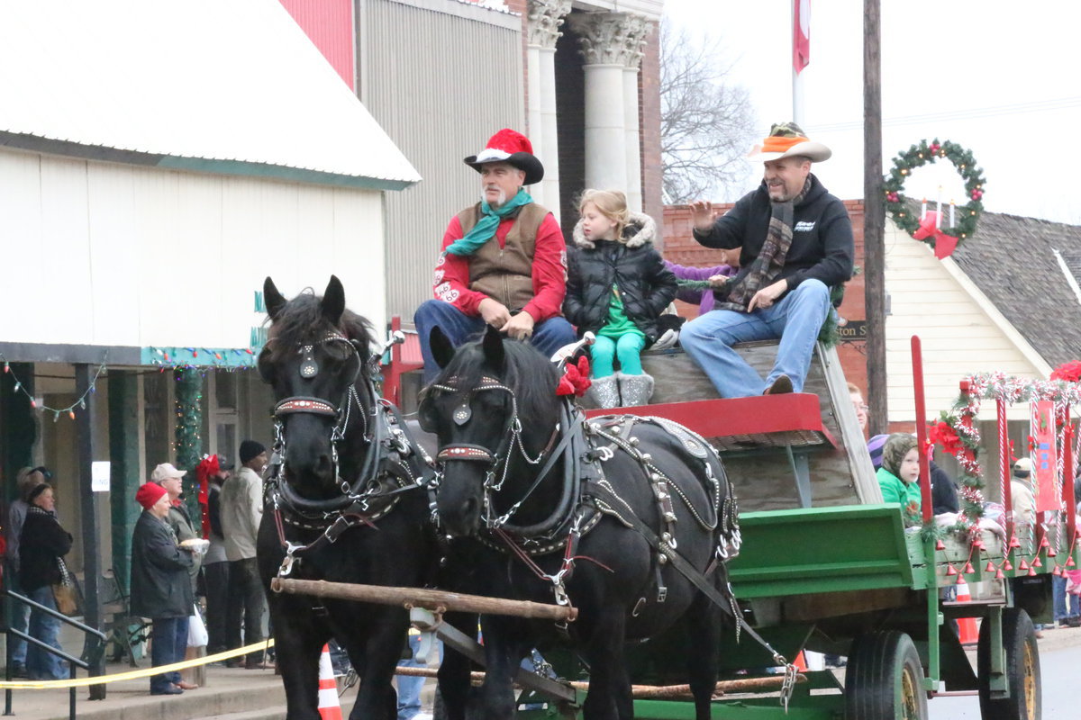 Image: The Stagecoach Cowboy Church provides a postcard-like image as their horse drawn wagon passes Italy City Hall.