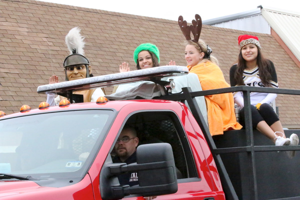 Image: Italy Fire Department Lieutenant Brad Chambers escorts Gladiator mascot Noeli Garcia and cheerleaders Ashlyn Jacinto, Britney Chambers and Jessica Garcia.