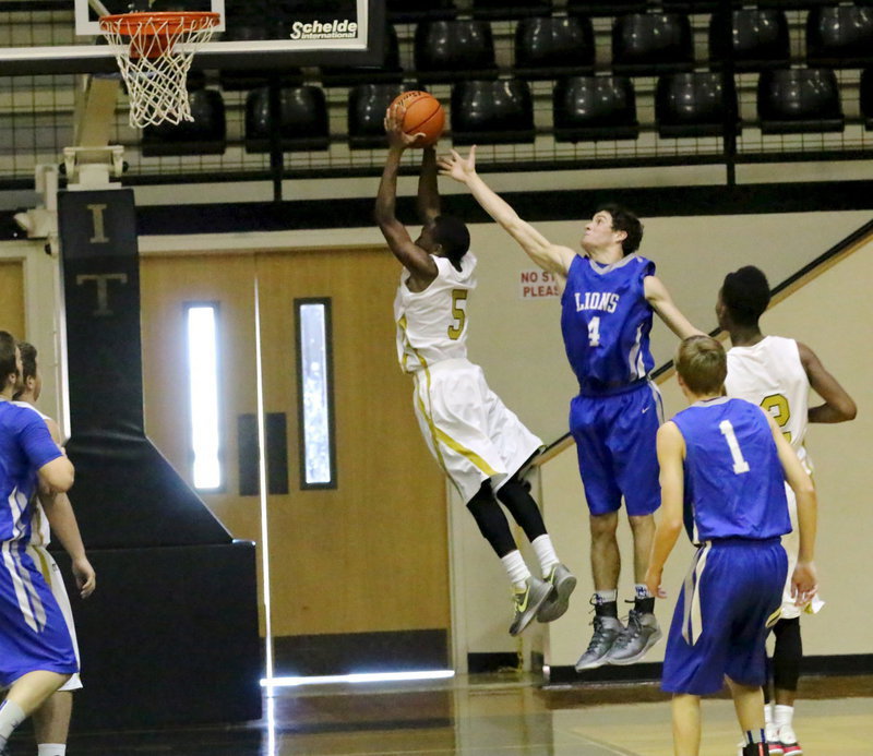 Image: Freshman guard Kevin Johnson(5) shows his versatility on the defensive boards.