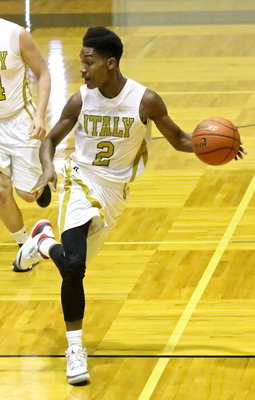 Image: Trevon Robertson(2) avoids Lion defenders while pushing the ball up the floor.