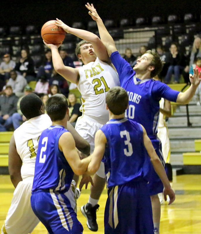 Image: Zain Byers(21) tries to power in a basket while drawing a shooting foul.