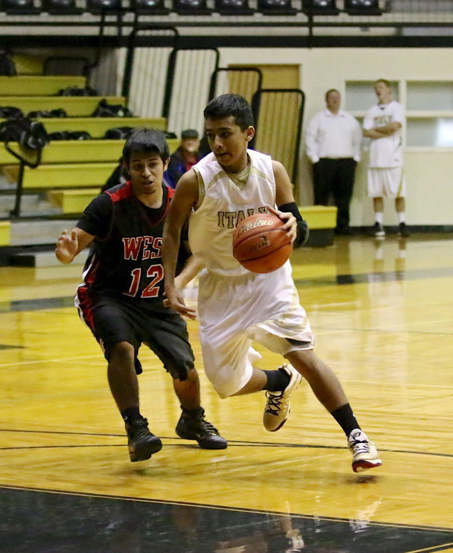 Image: JV Gladiator Jorge Galvan(2) slices into the lane against West.