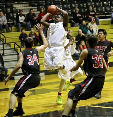 Image: Kenneth Norwood, Jr.(5) pulls up to take a jumper for the JV Gladiators over a couple of West defenders.
