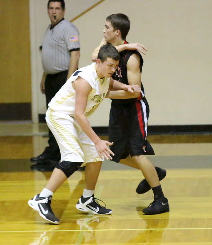 Image: Referee Don Garrison keeps an eye on the physical action between Italy JV Gladiator Austin Crawford(11) and a West player.