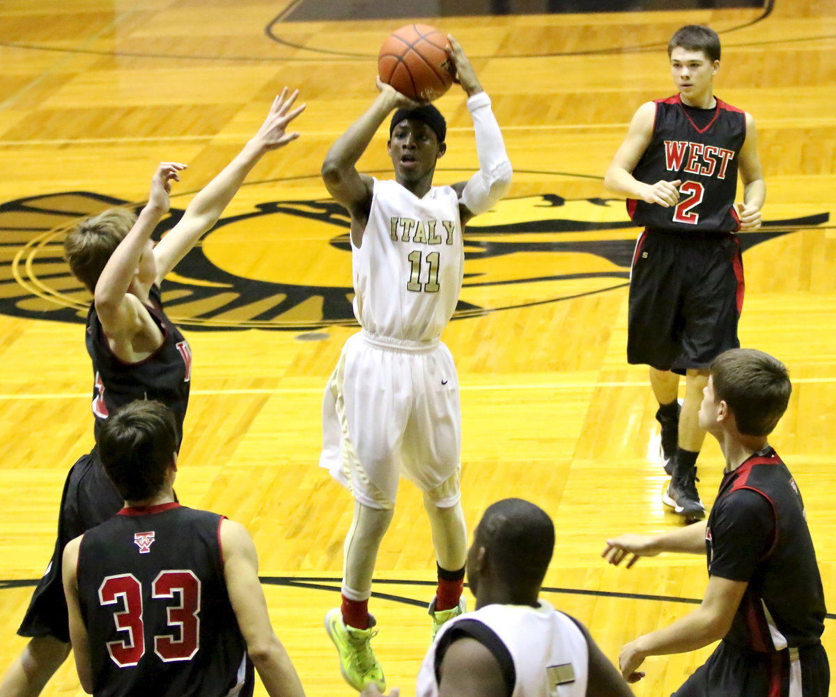 Image: Italy’s Eric Carson(11) pulls up to shoot the jumper over the West defense.