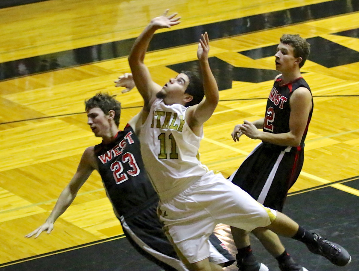 Image: Somehow, Tyler Anderson(11) gets the layup to drop in and then adds the and-1 to complete the 3-point play.