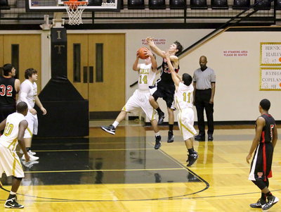 Image: Bailey Walton(14) snatches away a rebound from a West rebounder.