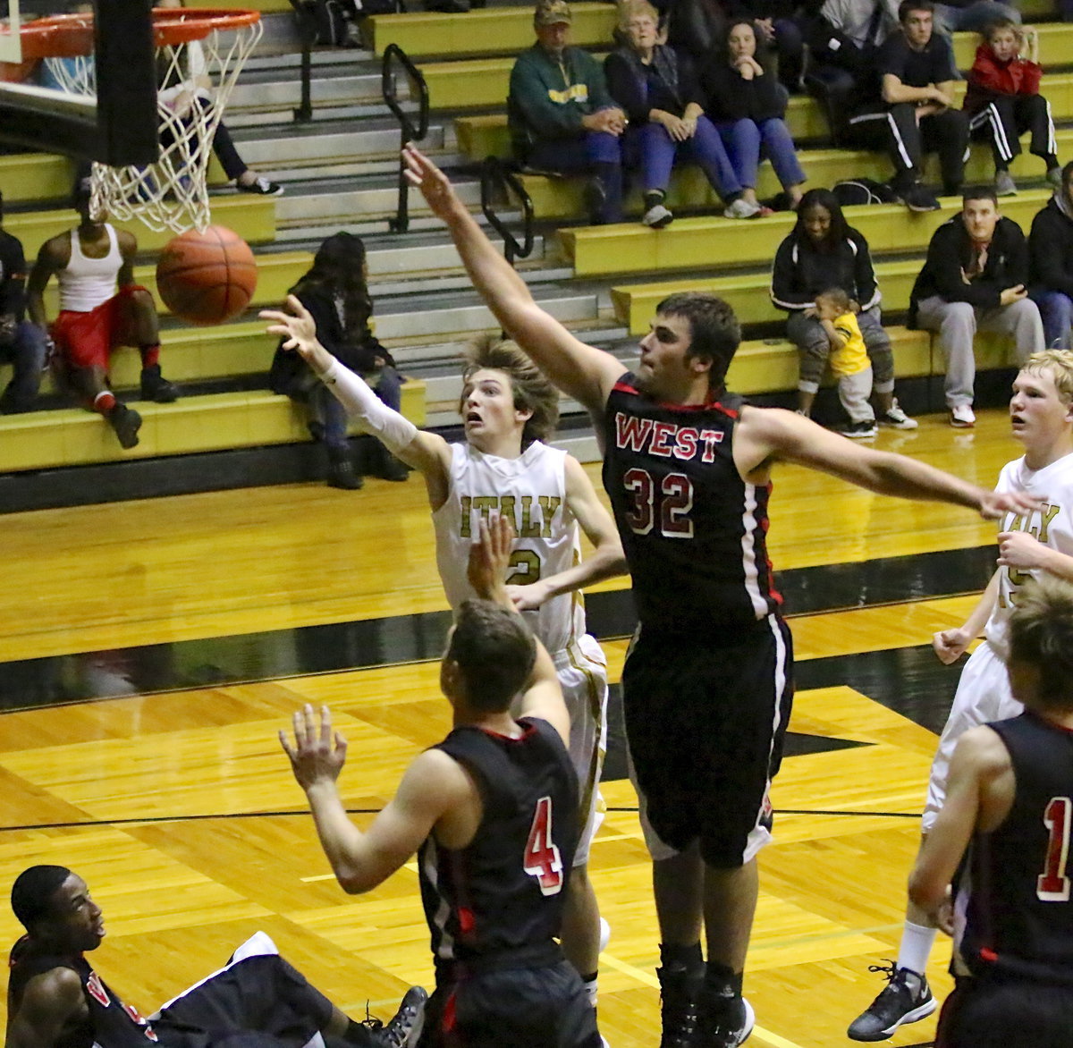 Image: Gladiator Ty Windham(12) goes up-and-under for the score and-1. Despite a physical effort from Italy, the visiting 3A West Trojans get the win to close out the holiday break.