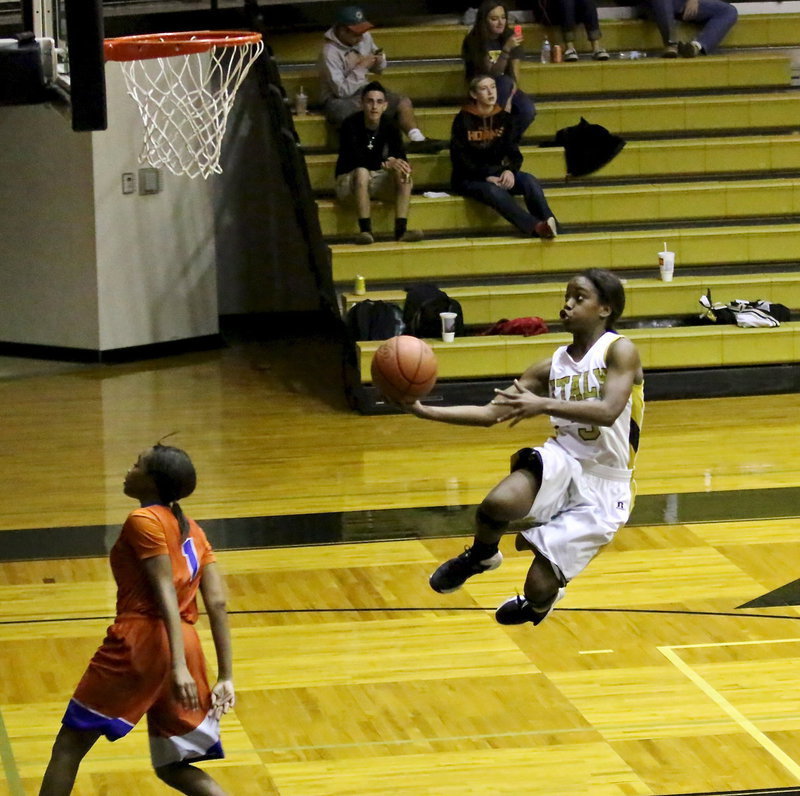 Image: Kortnei Johnson(13) gets creative to get a shot up.