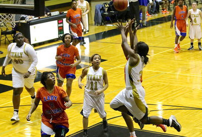 Image: Kortnei Johnson(3) tries to corral an alley-oop pass.