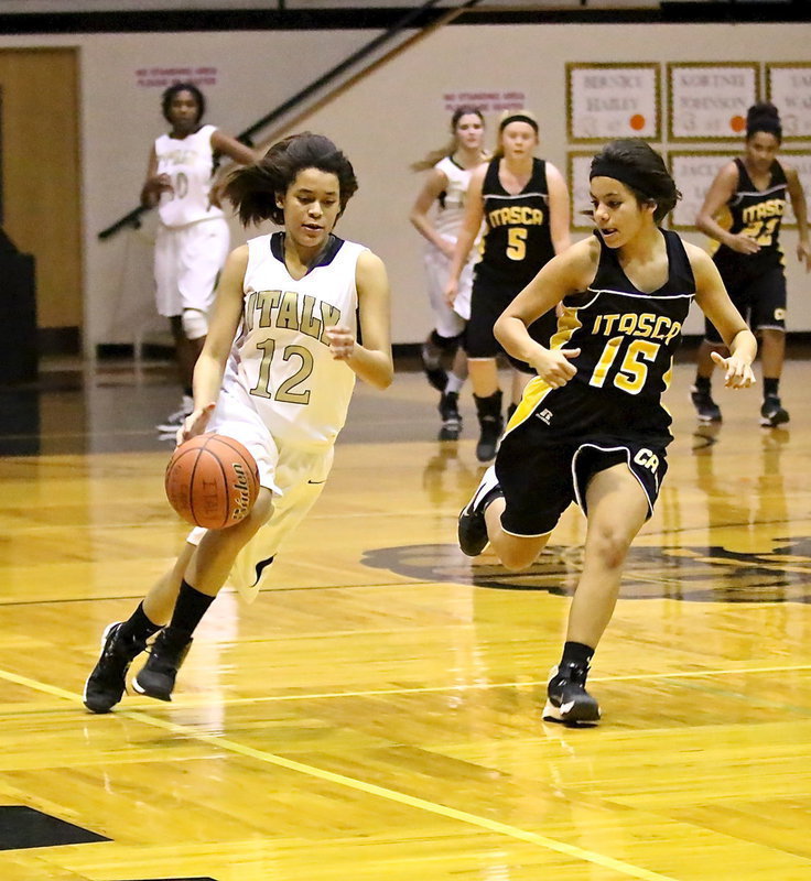 Image: Alex Minton(12) pushes the ball toward the basket.