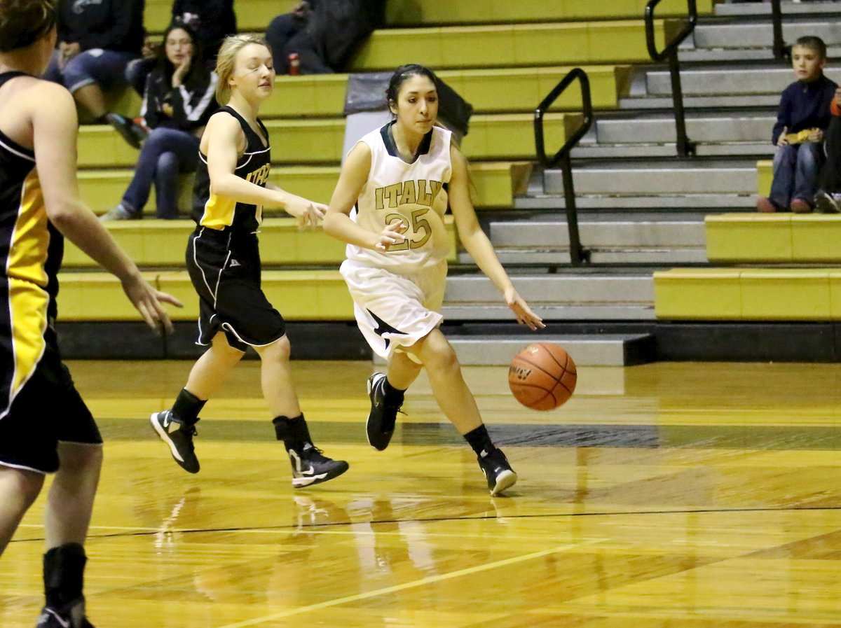 Image: Lizzy Garcia(25) drives toward the lane and puts up a short jumper.