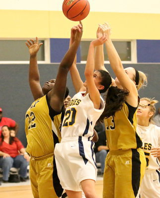 Image: Lady Gladiators Taleyia Wilson(22) and Jaclynn Lewis(13) fight for a rebound.