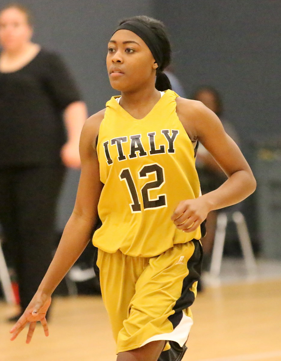 Image: K’Breona Davis(12) brings the ball up the court while eyeing the Eagle defensive set.