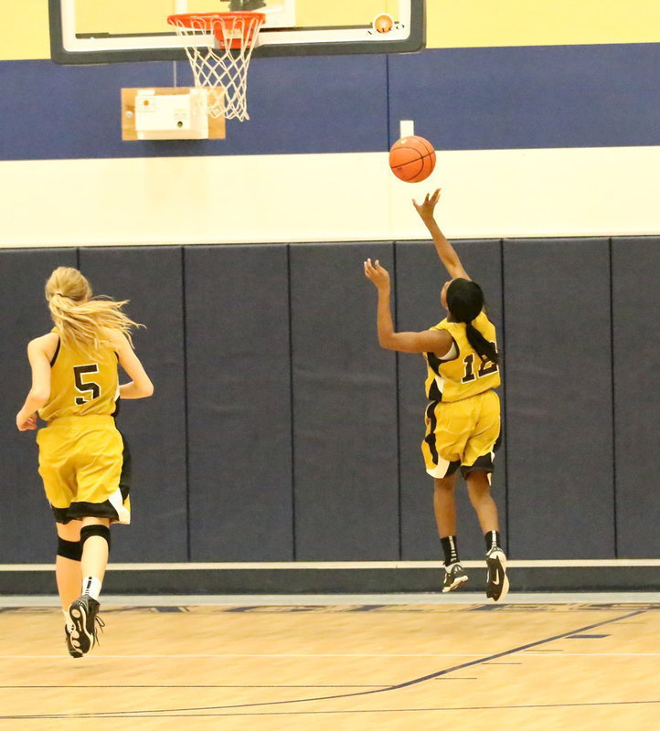 Image: K’Breona Davis(12) finishes the fast break for 2-points as teammate Haylee Turner(5) hustles down to back Davis up.