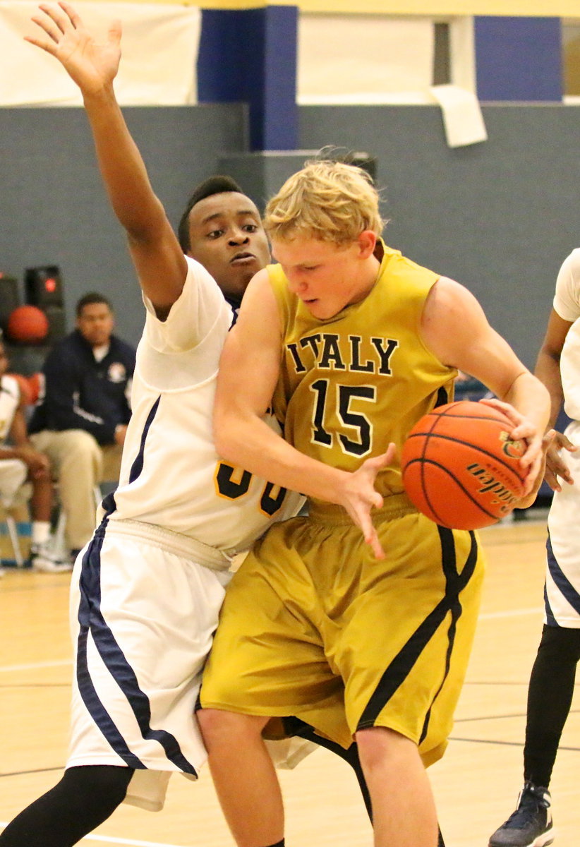 Image: Powering his way toward the basket is Italy’s Cody Boyd(15).