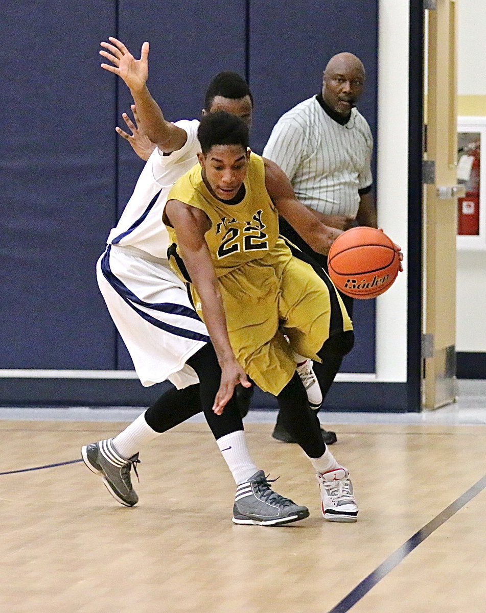 Image: Gladiator Tre Robertson(22) stays inbounds while dribbling thru an Eagle defender.