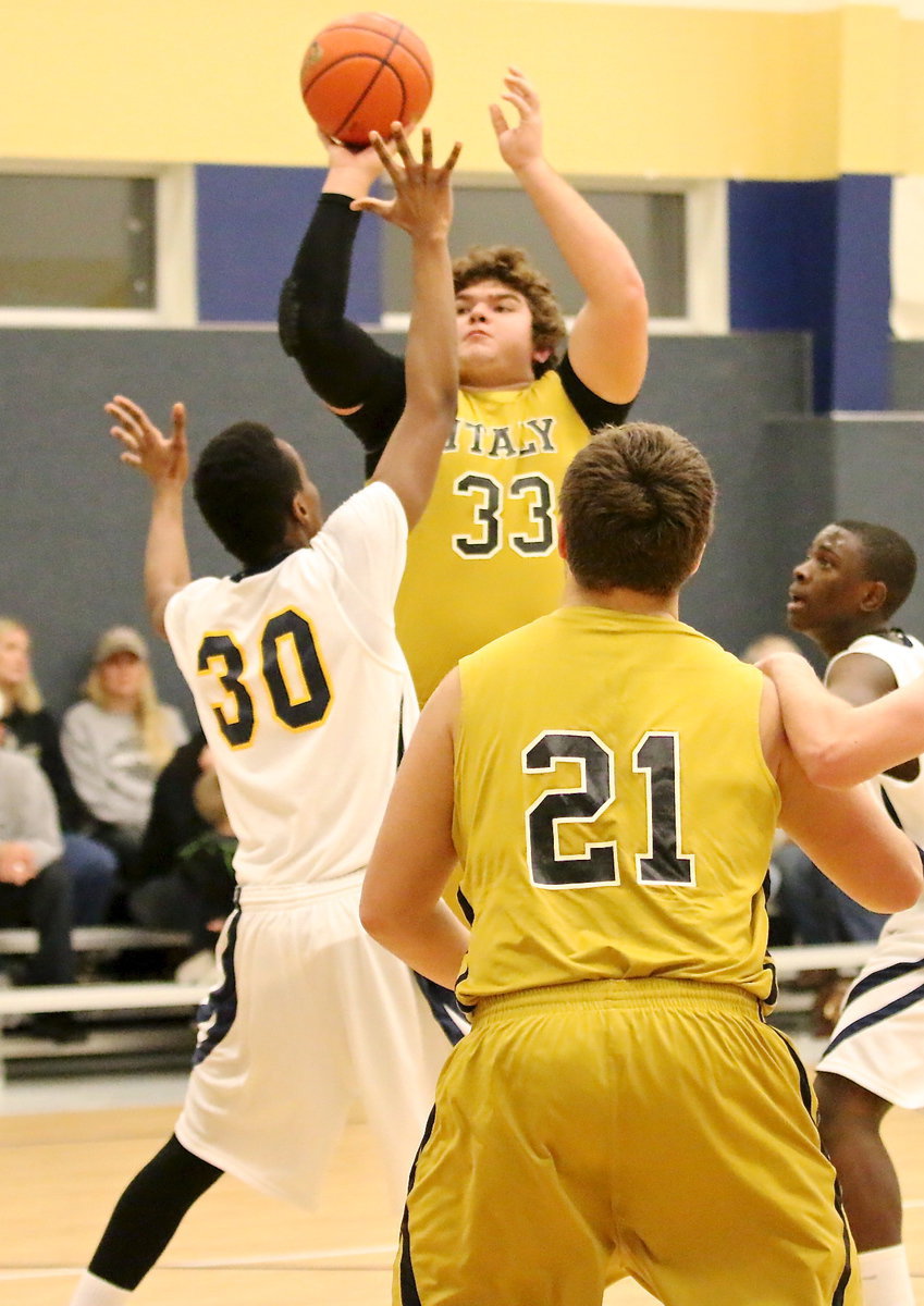 Image: Kevin Roldan(33) launches an assault on the basket in the second-half.