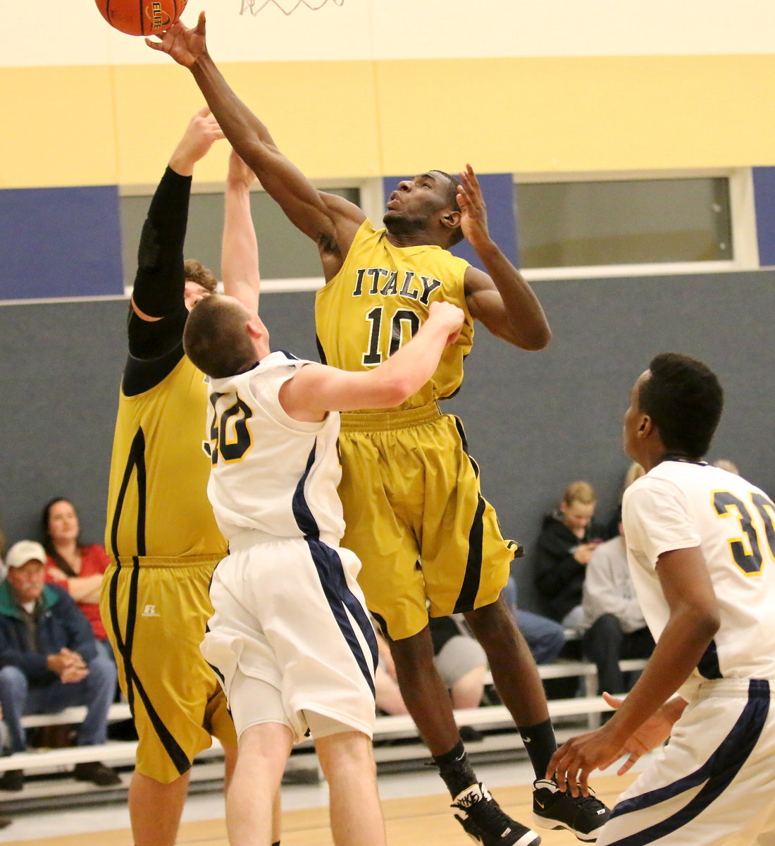 Image: TaMarcus Sheppard(10) and Kevin Roldan(33) challenge an Eagle for an offensive board.