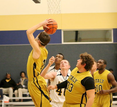 Image: Ryan Connor(1) gets up a shot from underneath the basket.