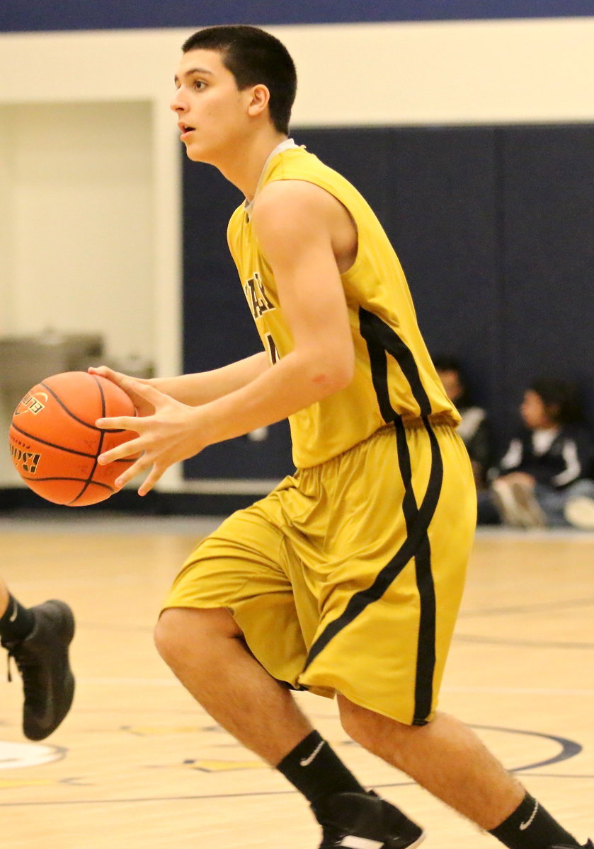 Image: Mason Womack(4) brings the ball across mid-court.