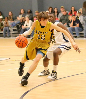 Image: Ty Windham(12) flies past an Eagle defender on his way to the basket.