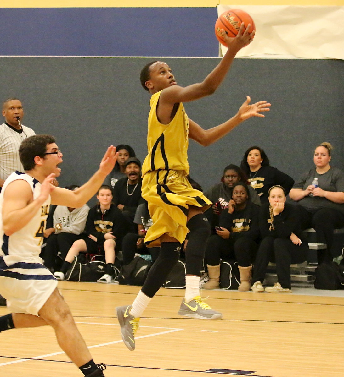 Image: Kevin Johnson(5) scores on the fast break with, “Bang,” and the Lady Gladiators glued to the action.