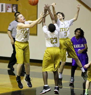Image: I got it! Clay Riddle(30), Anthony Lusk, Jr.(23) and Ty Hamilton(11) each go after the rebound.
