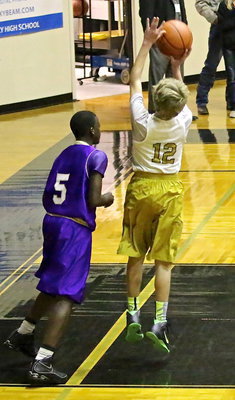 Image: Garrett Janek(12) puts up a shot under the basket.