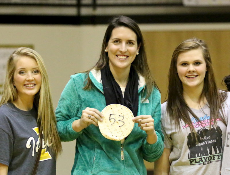 Image: Megann Lewis Harlow wins the Tortilla Toss fundraiser at halftime benefitting the Lady Gladiator Softball team. A former pitcher for the squad, Harlow poses with current players, Hannah Washington, Lillie Perry and her lucky tortilla worth $20.00.