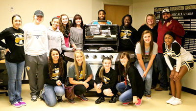 Image: Thumbs up! Capping off an exciting night of Italy Basketball was the Lady Gladiator Softball team presenting Cristie and Eric Enriquez (far right) with their new grill they won with their raffle ticket purchases.
    The Brinkman ProSeries Grill was donated by the Brinkman Corporation.
