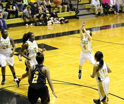 Image: Point guard Tara Wallis(4) spots and then drops in a three-pointer in the first-half.