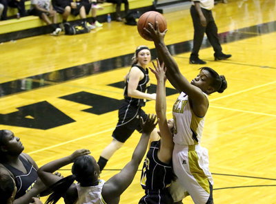 Image: Kortnei Johnson(3) bounds for the defensive rebound over an Itasca player.