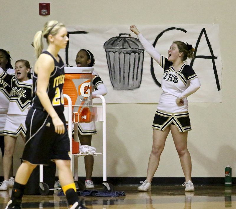 Image: Senior cheer captain, Taylor Turner, gets help from the Jr. High cheer squad with Italy trying to close the lid on Itasca.