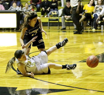 Image: Tara Wallis(4) dives after an offensive rebound to keep the possession alive for her team.