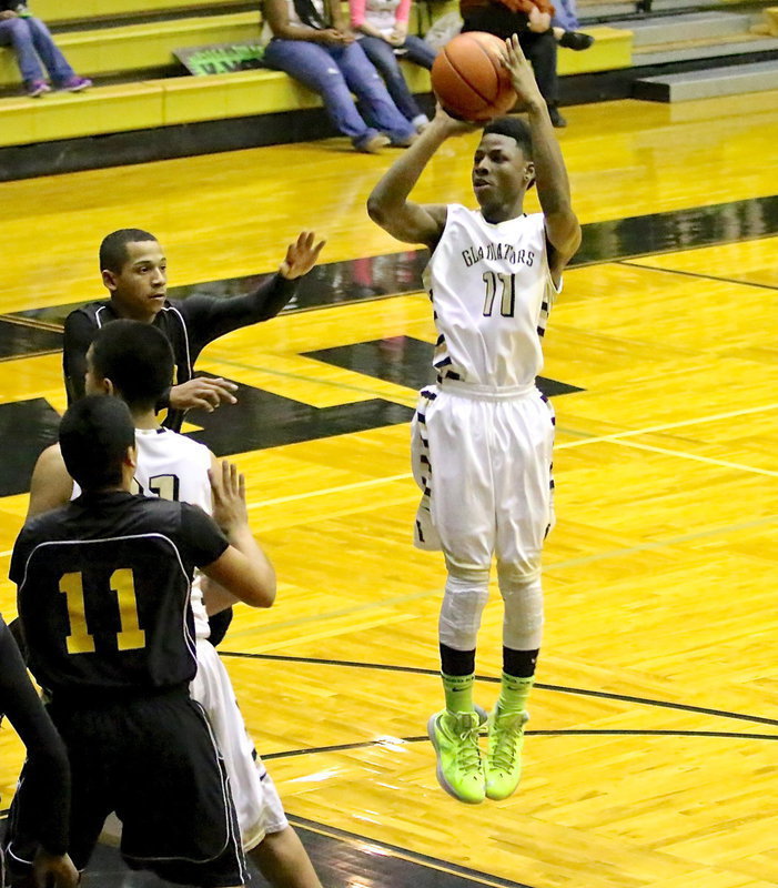 Image: Eric Carson(11) knocks down a jump shot during the JV Gladiator game against Itasca.