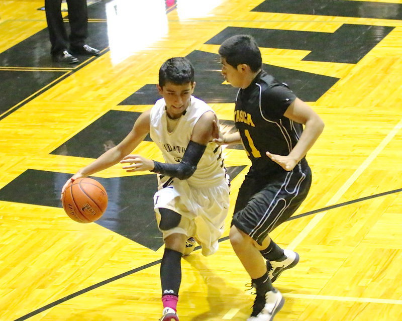 Image: Jorge Galvan(2) works his way closer to the basket.