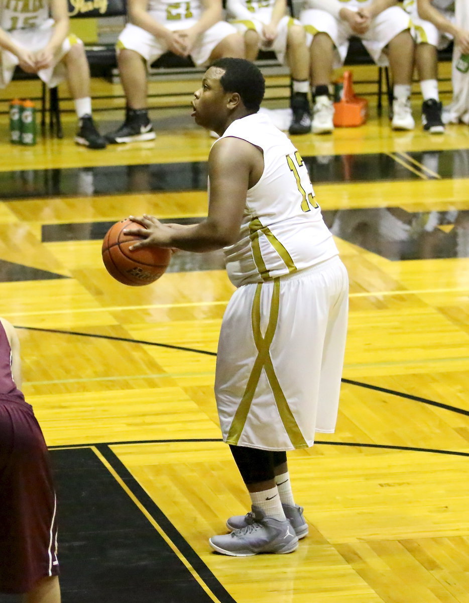 Image: Senior Gladiator, Darol Mayberry(13) sets up to attempt a free-throw. Mayberry made 3-of-4 from the stripe and finished with 5-points against Summit.