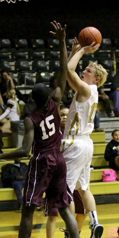 Image: Cody Boyd(15) twists in 2 of his 9-points over a SkyHawk defender.