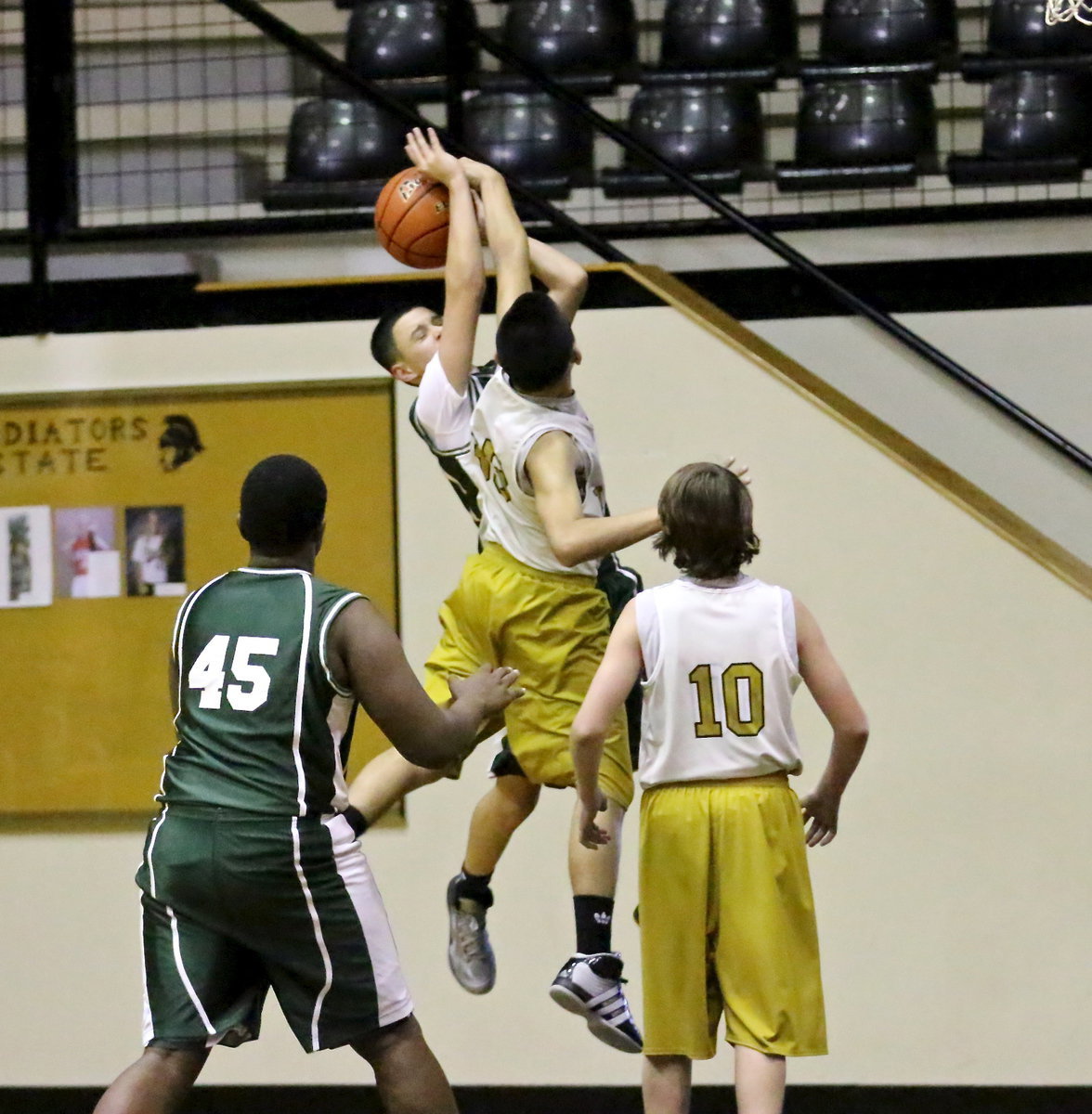 Image: Jonathan Salas(35) denies a Scurry shooter a chance to put up a shot.