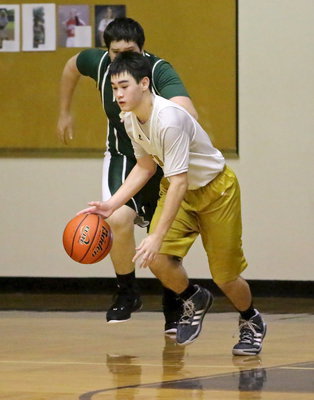 Image: 8th grader, Kyle Tindol(25) grabs the rebound and then takes off to the other side.