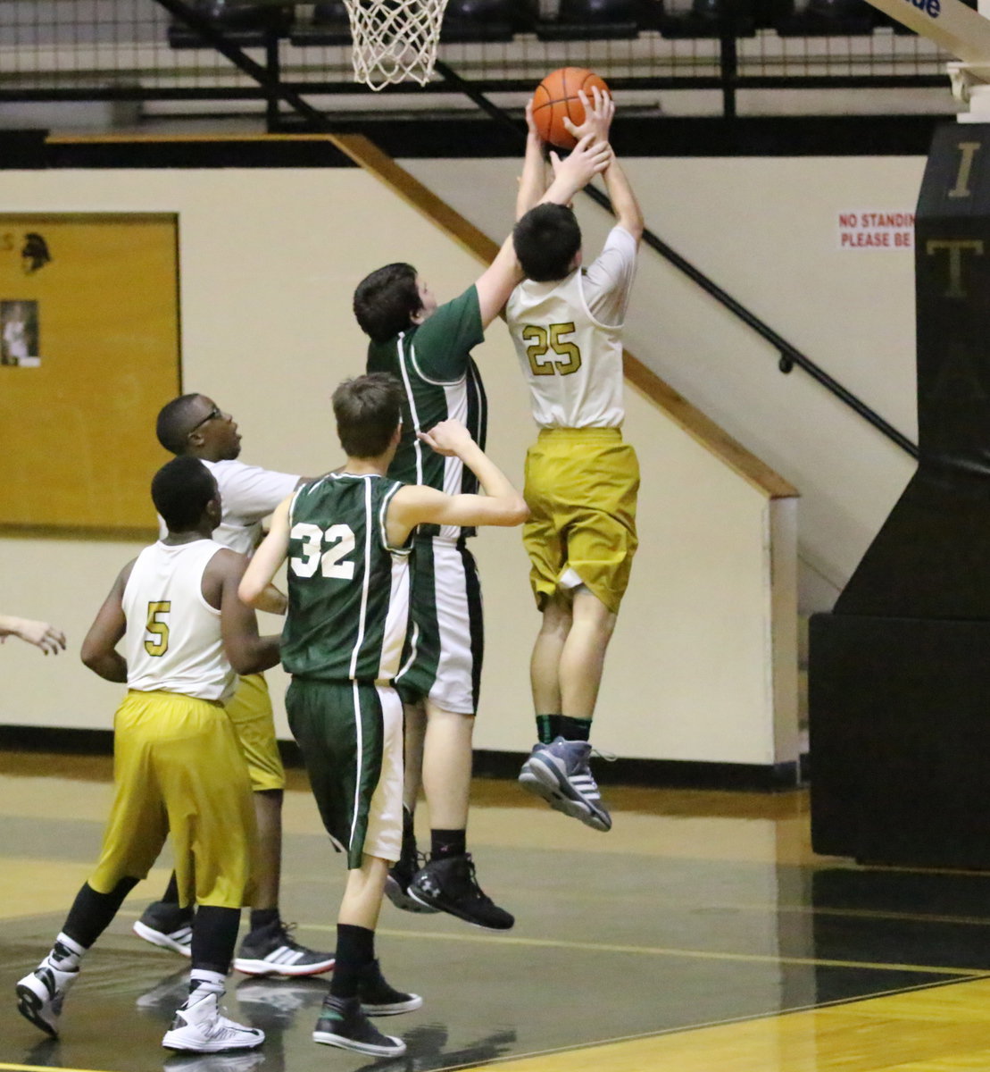 Image: Kyle Tindol(25) tears down another rebound for Italy’s 8th graders.