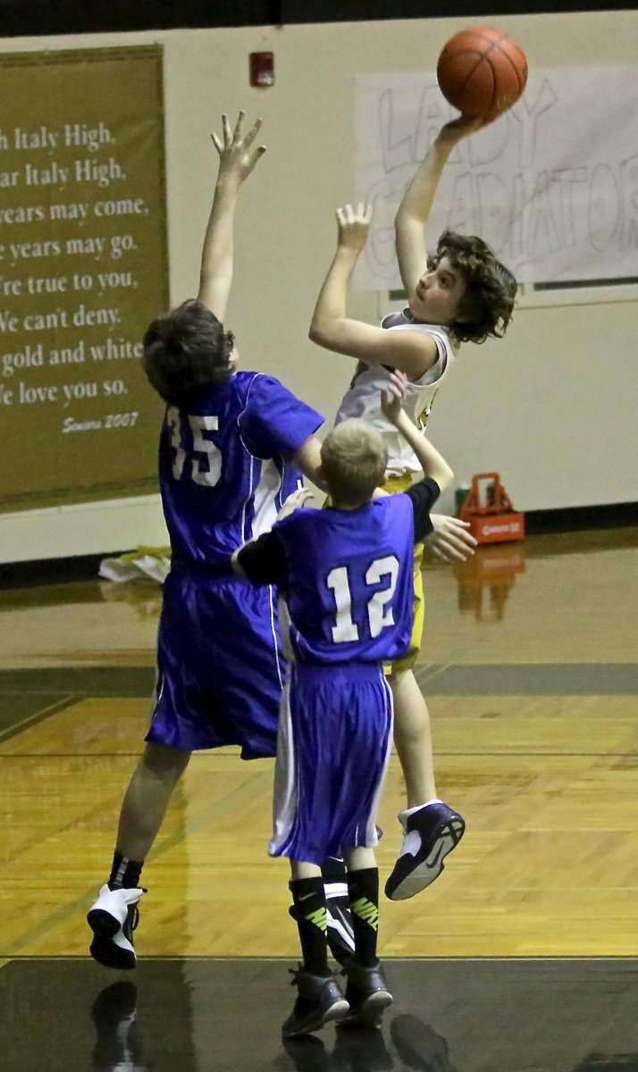 Image: Andrew Oldfield(13) scores over two Rice defenders for the “Combo-ators” a squad comprised of a mixture of Italy Junior High 7th and 8th graders.