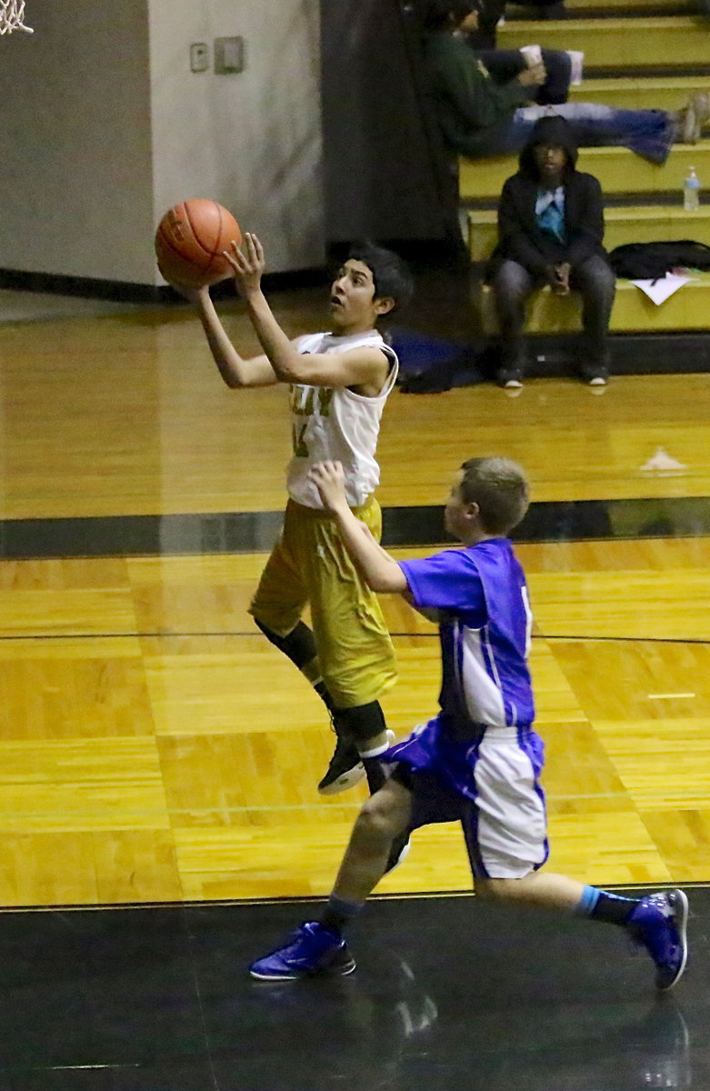 Image: Marcoz Duarte(14) scores at the end of a fast break opportunity.